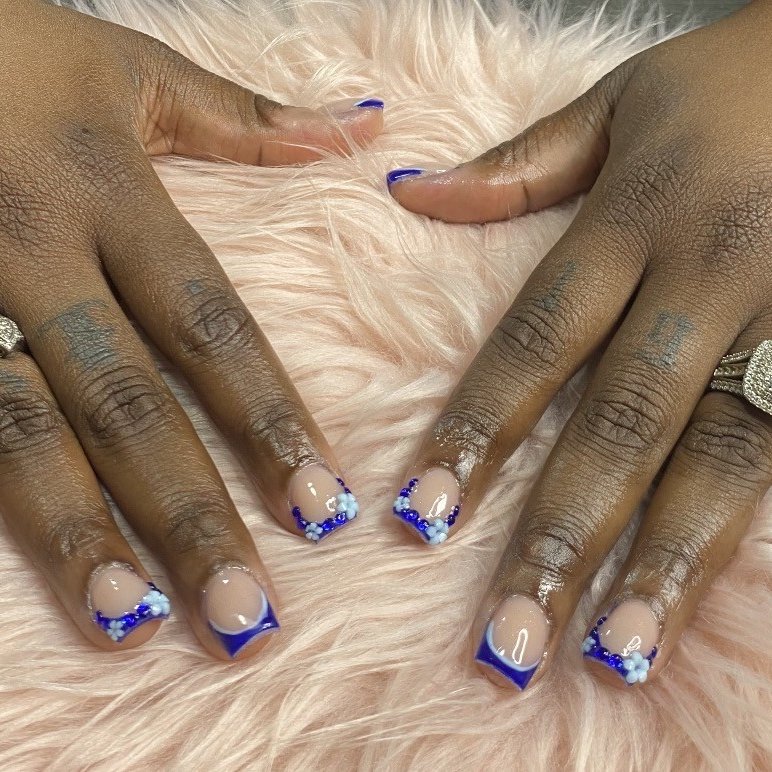 Blue French tip acrylic set with 3D flower accents by Lovely K Nails